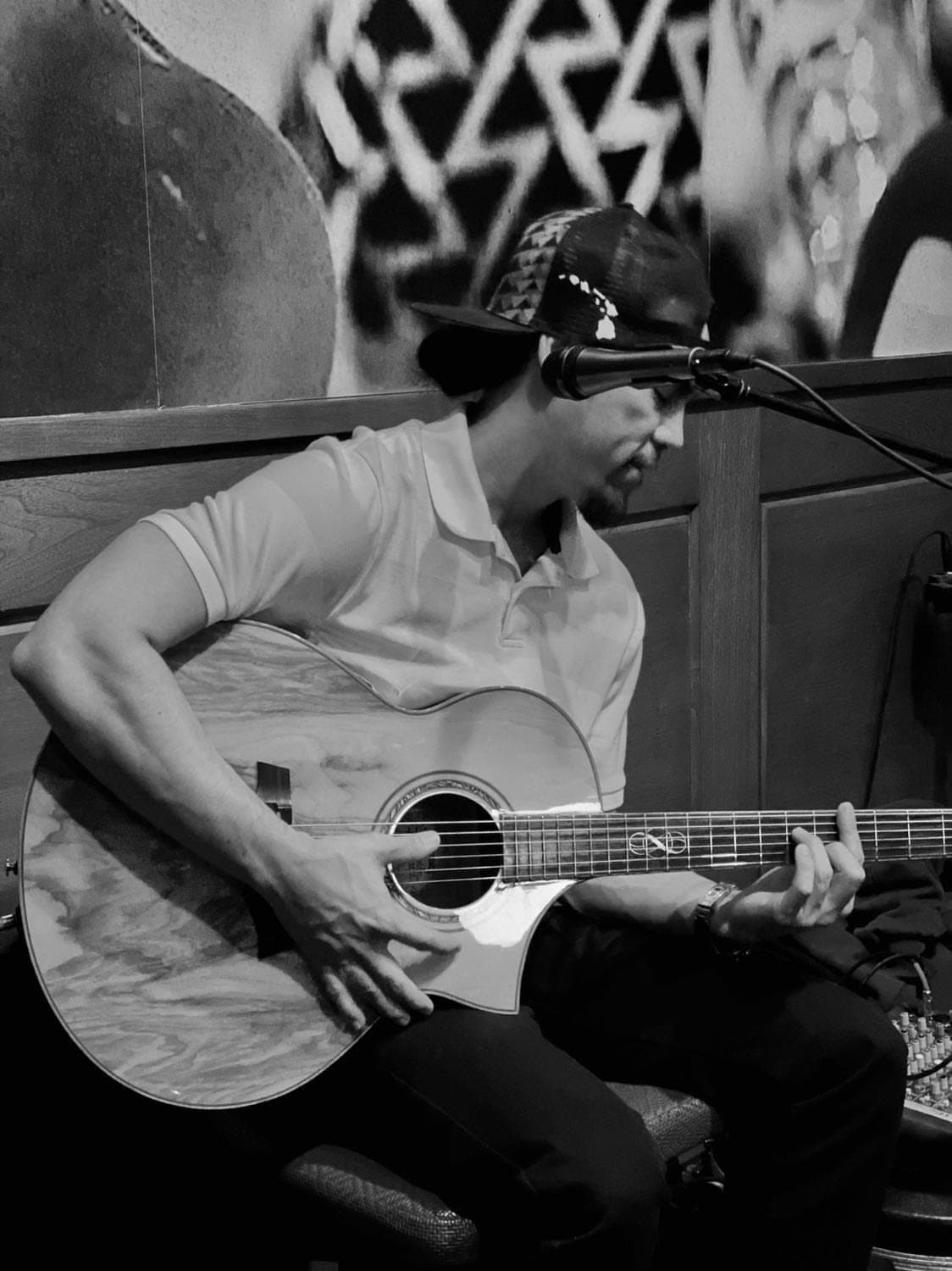 Black and white photo of Kekoa playing guitar